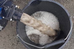 Dirty water and chemical residue from hot water extraction machine